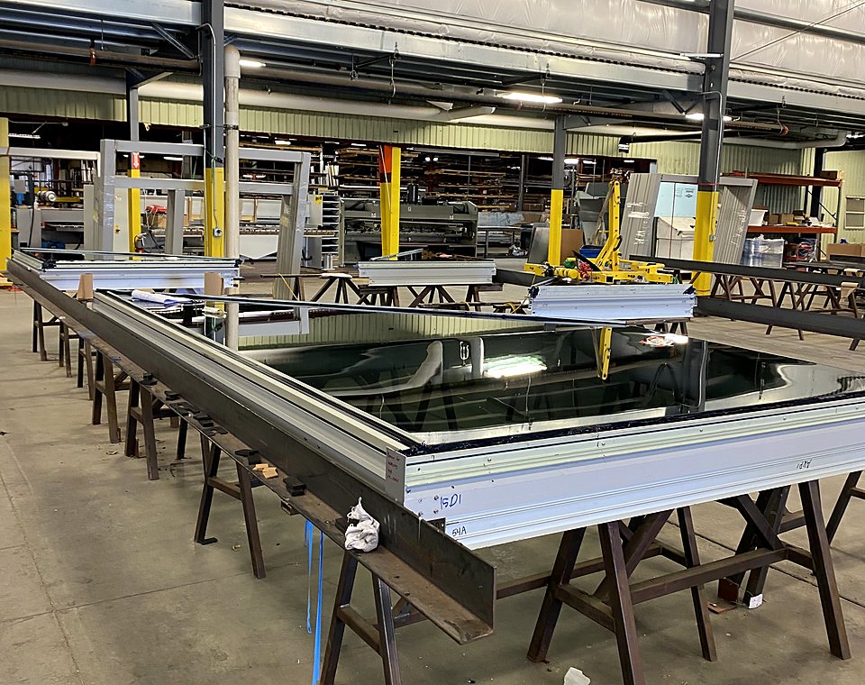 Glazed unitized frame on assembly tables at the Farmington plant
